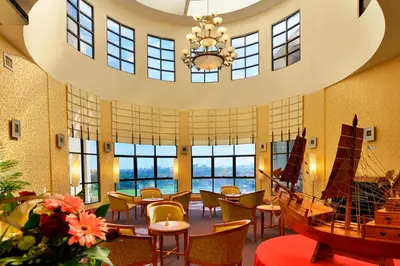 a large room with tables and chairs and a boat in it at Pearl View Hotel Prai, Penang in Perai