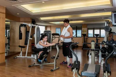 a man and a woman exercising in a gym at Pearl View Hotel Prai, Penang in Perai