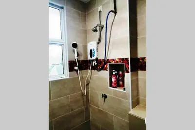 a bathroom with a shower with a shower at Bintang Maya Residence cozy and comfortable stay in Sungai Petani