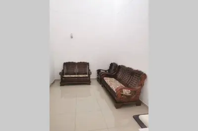 two chairs and a couch in a room at Bintang Maya Residence cozy and comfortable stay in Sungai Petani