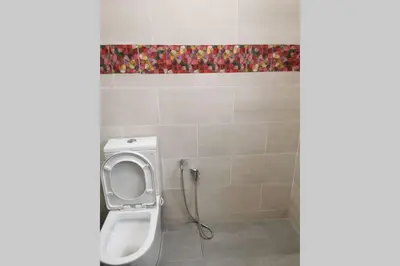 a bathroom with a white toilet in a room at Bintang Maya Residence cozy and comfortable stay in Sungai Petani