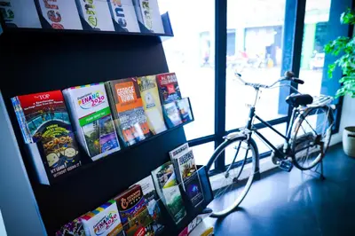 a bike parked in a room with books at The Journey hotel in George Town