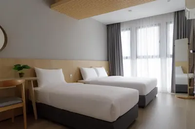 a hotel room with two beds and a window at The Journey hotel in George Town