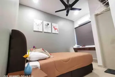 a bedroom with a bed with a ceiling fan at PANGKOR 66’s HOME in Kampong Sungai Udang
