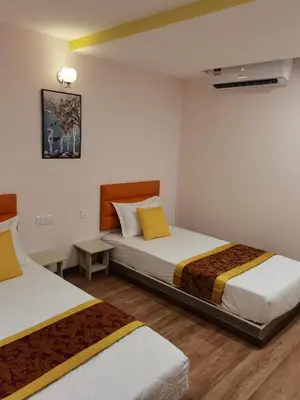a bedroom with two beds and a tv in it at MORNINGS HOTEL in Sungai Petani
