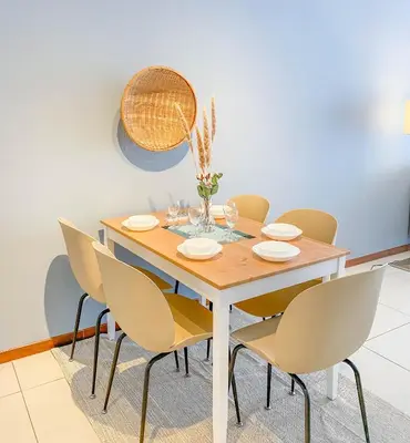 a dining room with a wooden table and chairs at The Landmark - Merveilles MOGERCS in George Town