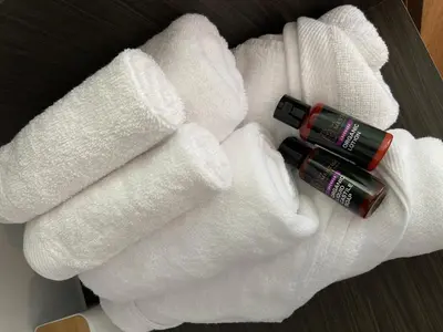 a pair of white towels with a bottle ofatio at Ten Mentigi in Tanah Rata