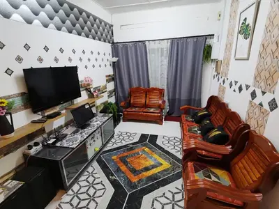 a living room with two chairs and a flat screen tv at MN HOMES in Ipoh