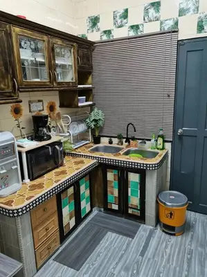 a kitchen with a sink and a stove top oven at MN HOMES in Ipoh