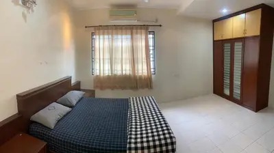 a bedroom with a bed with a checkered blanket at Awani Homestay Seberang Jaya in Permatang Janggus