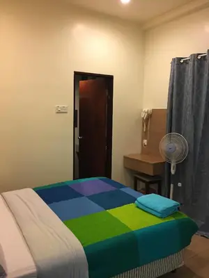 a bedroom with a bed with a colorful blanket at CH Green Stay Resort Apartment in Cameron Highlands