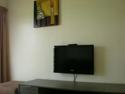 a flat screen tv sitting on a wall at CH Green Stay Resort Apartment in Cameron Highlands