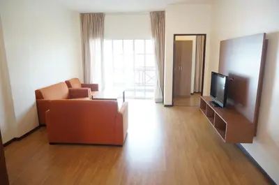 a living room with a couch and a television at CH Green Stay Resort Apartment in Cameron Highlands