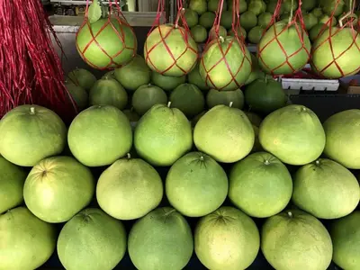 a pile of green apples on display at a market at Just Austin Guesthouse in Ipoh