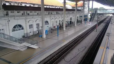 a train station with a rain soaked platform at Just Austin Guesthouse in Ipoh