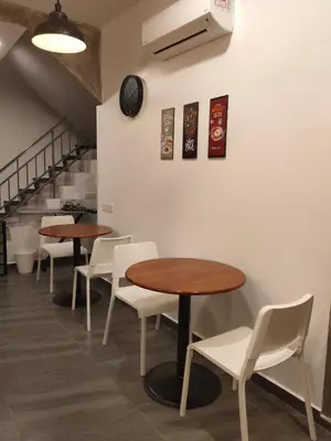 a row of tables and chairs in a restaurant at Just Austin Guesthouse in Ipoh