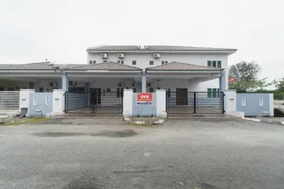 a white building with a gate in front of it at Guesthouse Fasa 2B in Seri Manjung