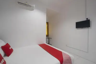 a small white room with a red and white bench at Guesthouse Fasa 2B in Seri Manjung
