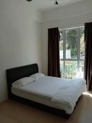 a bed in a bedroom with a large window at Zarena Somersquare Goldenhills Pasar Malam Tanah Rata Cameron Highlands in Tanah Rata