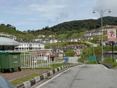 an empty street in a small town with houses at Zarena Somersquare Goldenhills Pasar Malam Tanah Rata Cameron Highlands in Tanah Rata