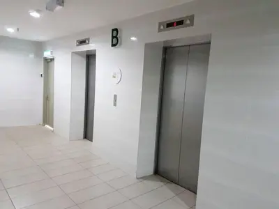a hallway with two elevators and a b sign on a wall at Zarena Somersquare Goldenhills Pasar Malam Tanah Rata Cameron Highlands in Tanah Rata
