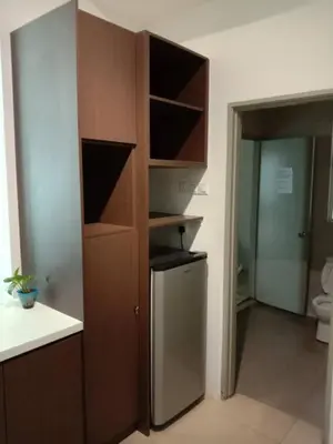 a kitchen with a cupboard and a refrigerator at Zarena Somersquare Goldenhills Pasar Malam Tanah Rata Cameron Highlands in Tanah Rata
