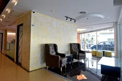 a waiting room with two chairs and a wall at Jindagu Hotel Ipoh in Ipoh