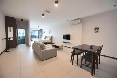 a living room with a couch and a table at The Landmark by Katana - Your Home Away From Home in Tanjong Tokong
