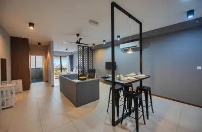 a living room with a table and a couch at The Landmark by Katana - Your Home Away From Home in Tanjong Tokong