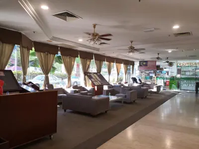 a waiting area with couches and chairs in a store at Pangkor staycation apartment in Pangkor