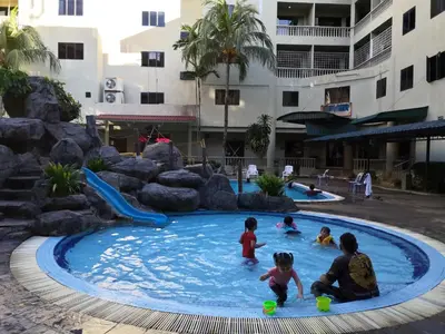 a group of children playing in a swimming pool at Pangkor staycation apartment in Pangkor