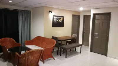 a room with a table and chairs and a table and a table at Pangkor staycation apartment in Pangkor