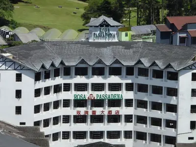 a white building with a sign on top of it at Bugdet Apartment in Brinchang