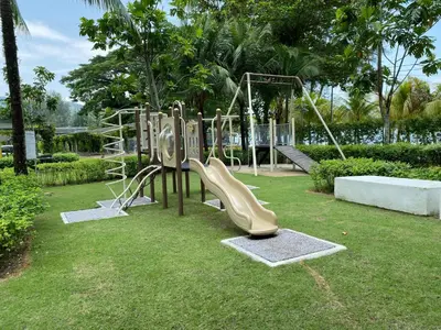 a playground with a slide in a park at By The Sea Cozy Beachfront Home, Batu Ferringhi in Batu Ferringhi