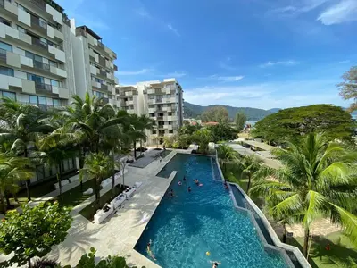 an overhead view of a swimming pool in a resort at By The Sea Cozy Beachfront Home, Batu Ferringhi in Batu Ferringhi