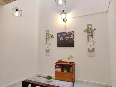 a room with a table and flowers on the wall at SS Ipoh Comfort Homestay - Taman Bertuah in Ipoh