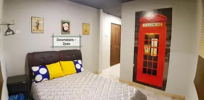 a bedroom with a red phone booth and a bed at G East Ipoh Garden Guesthouse in Ipoh