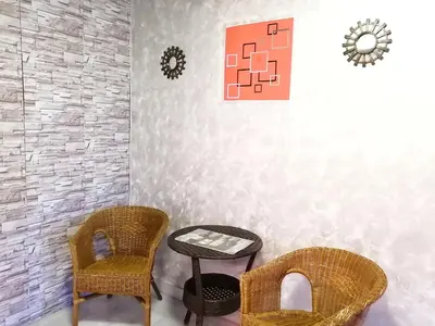 two chairs and a table in a room at G East Ipoh Garden Guesthouse in Ipoh