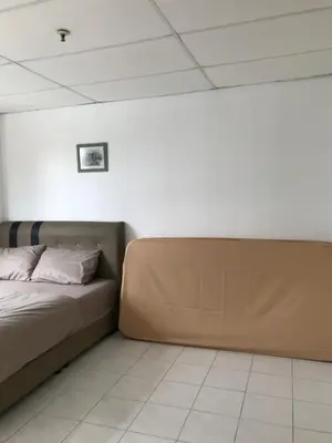 a couch in a room with a white wall at Pangkor Coralbay Resort 201 apartment in Pangkor