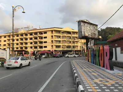 a city street with a building and cars on the road at Pangkor Coralbay Resort 201 apartment in Pangkor