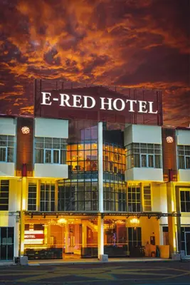 a red hotel with a sign on top of it at ERNES Hotel Alma Bukit Mertajam in Bukit Mertajam