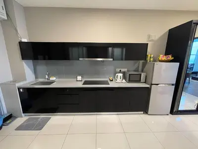 a kitchen with a sink and a microwave at Maritime Seaview Hotel by SS Setia Resort in George Town