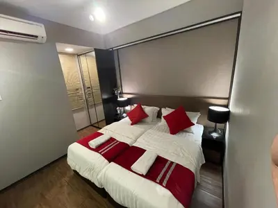 a bedroom with a large bed with red and white pillows at Maritime Seaview Hotel by SS Setia Resort in George Town