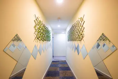 a hallway with plants on the wall at Sun Inns Hotel Meru Raya in Chemor