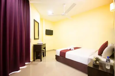 a hotel room with a bed and a tv at Sun Inns Hotel Meru Raya in Chemor
