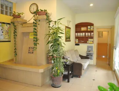 a living room with potted plants and a fireplace at Sun Inns Tambun in Kampong Batu Lapan