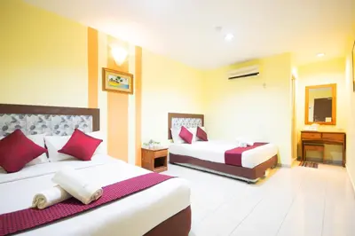 a hotel room with two beds and a television at Sun Inns Tambun in Kampong Batu Lapan