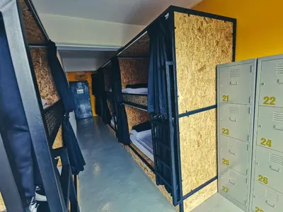 a group of bunk beds in a room with lockers at The Cocoon Capsule Hotel in Cameron Highlands