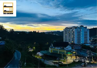 a view of a city with a tall building at The Cocoon Capsule Hotel in Cameron Highlands