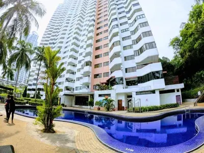 a building with a swimming pool in front of a building at Airbnb at Sri Sayang Batu Ferringhi Beach in Batu Ferringhi